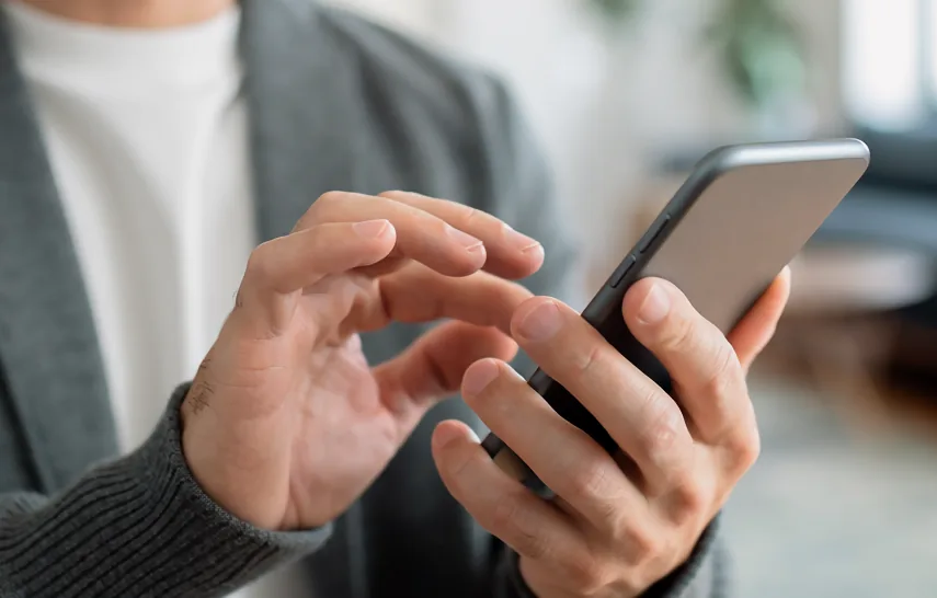スマートフォンで公式SNSを閲覧する男性